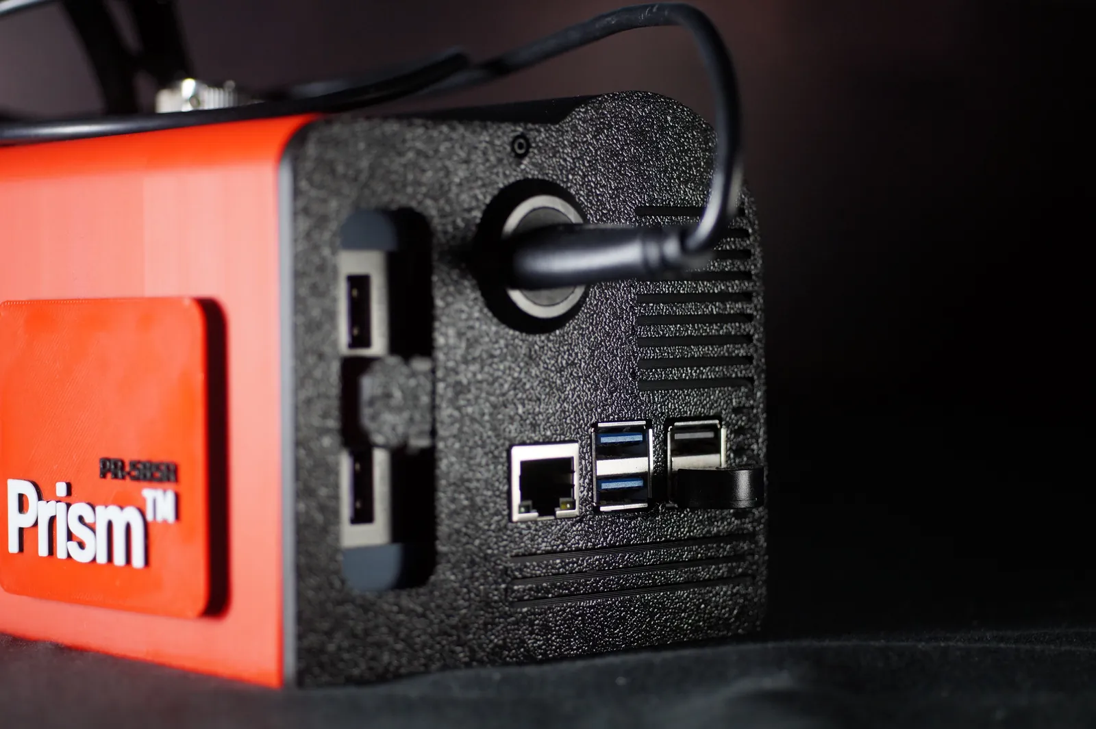 The rear of the camera: the power bank bay, a round port with the monitor cable, and the Raspberry Pi's Ethernet and USB ports
